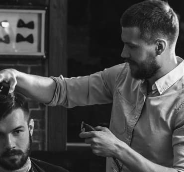 Barber is cutting a client's hair