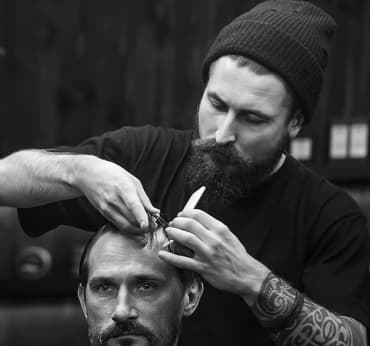 Barber is cutting a client's hair