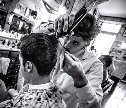 Barber cuts the customer’s hair
