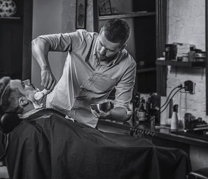 Barber cuts the customer’s hair